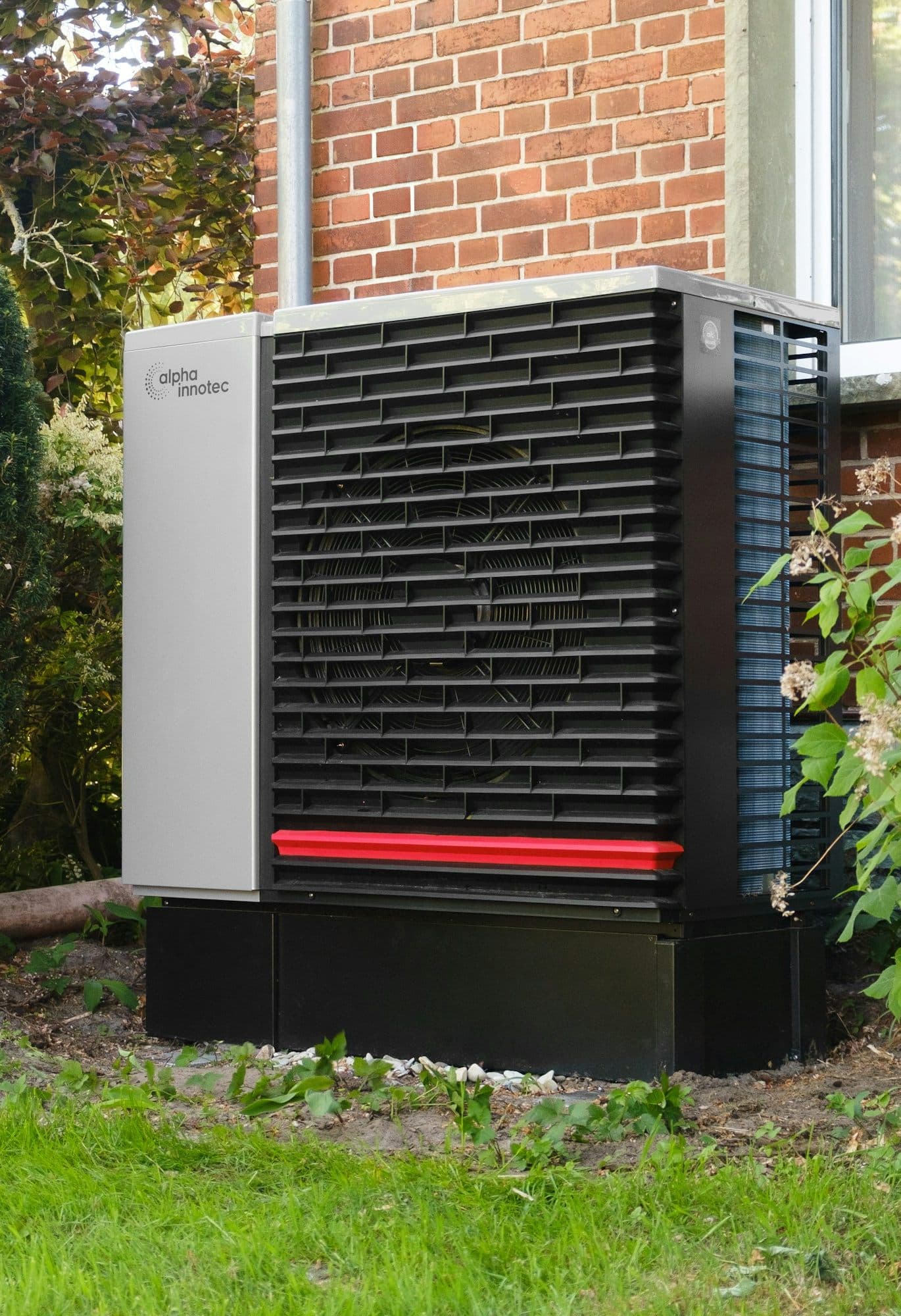A heat pump installed outside a brick home